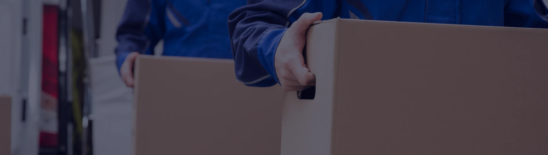 close up of two movers carrying a box